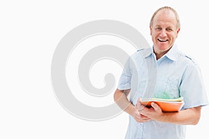 Happy mature student holding notebooks