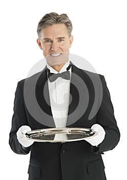 Happy Mature Waiter In Tuxedo Holding Serving Tray