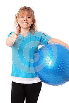 Happy mature woman in blue workout clothes feeling great