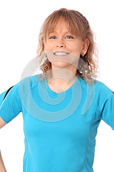 Happy mature woman in blue workout clothes feeling great