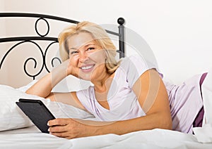 Happy mature woman with eBook