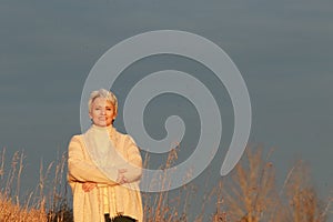 Happy mature woman in the evening sun