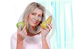 Happy mature woman with fruits