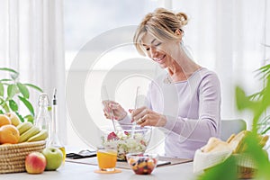 Happy mature woman having lunch break