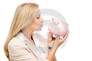 Happy Mature woman holding piggy bank isolated on white background
