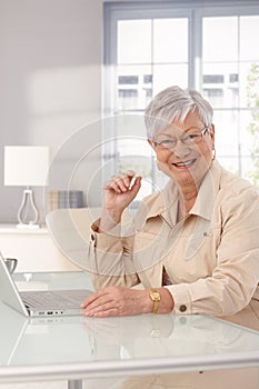 Happy mature woman with laptop