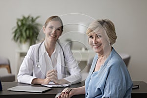 Happy mature woman looking at camera during visit in clinic