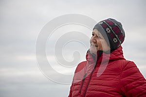 Happy mature woman outdoors on a cold day