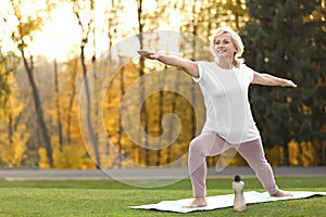 Happy mature woman practicing yoga. Active lifestyle