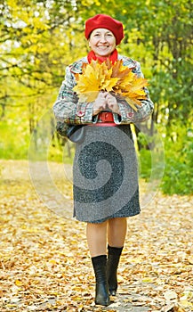 Happy mature woman walking outdoors