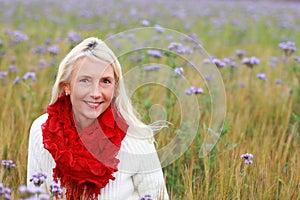 Happy matured woman in flowerfield