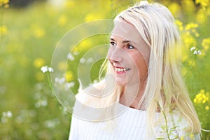 Happy matured woman in flowerfield photo