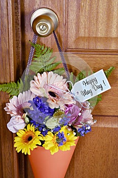 Happy May Day gift of flowers on door.