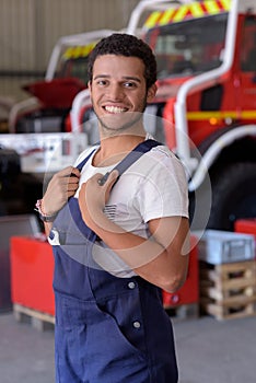 happy mechanic man holding wrench