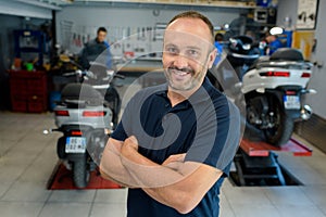 happy mechanic man looking at camera