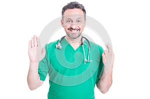 Happy medic or doctor doing a falsehood statement photo