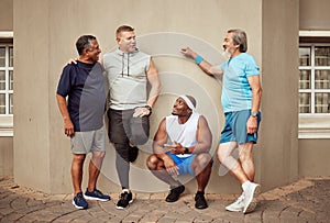 Happy men, fitness break and group exercise on wall background in urban city. Smile, sports training and male friends