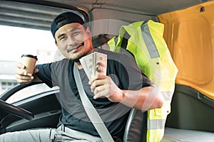 Happy men truck driver holding banknote US dollar