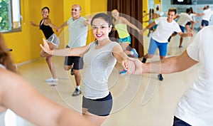 Happy men and women enjoying active dance