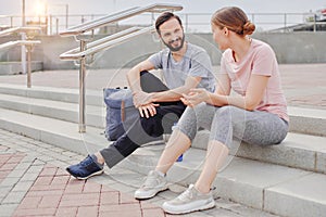 Couple sportsmen chatting outdoor, preparing for training