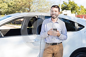 Happy Mid Adult Man Standing Next To His Car