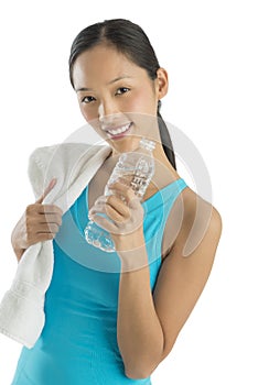 Happy Mid Adult Woman With Towel And Water Bottle