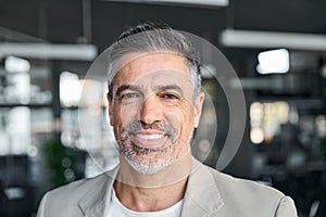 Happy mid aged business man ceo standing in office. Headshot portrait