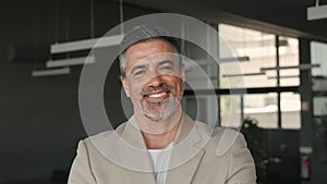 Happy mid aged business man ceo standing in office. Headshot portrait