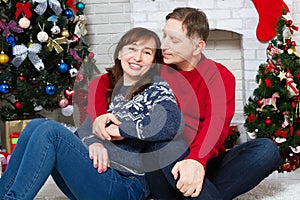 Happy middle age couple in christmas fire place in home, New Year celebration