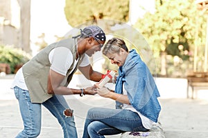 Happy middle age interracial couple sitting . Man giving Valentine& x27;s day gift to his woman,girlfriend or wife