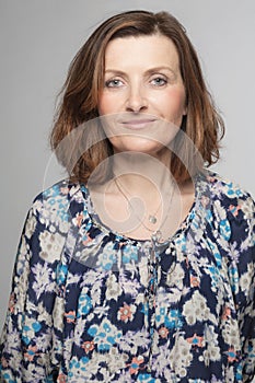 Happy middle age woman posing in studio.