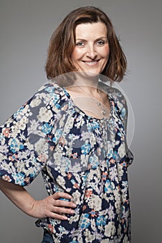 Happy middle age woman posing in studio.