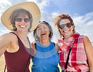 Happy middle age women posing together on vacation