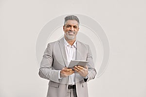 Happy middle aged business man using digital tablet isolated om white, portrait.
