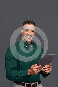 Happy middle aged business man using digital tablet, isolated, portrait.