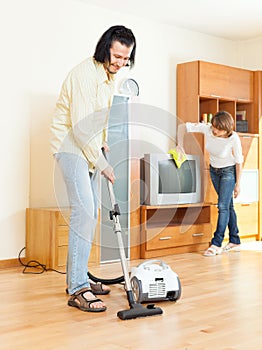 Happy middle-aged couple doing housework