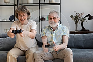 Happy middle aged couple playing video games together.