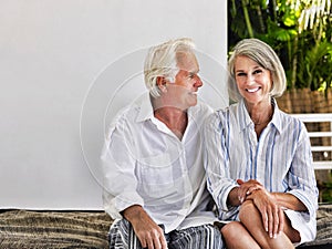 Happy middle aged couple sitting on verandah photo