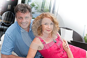 Happy middle aged couple spending romantic time by pool