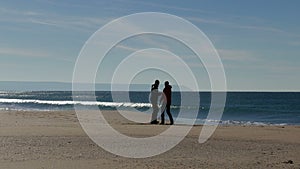 Happy Middle-aged Couple Walking on Beach