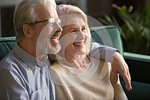 Happy middle-aged family, wife and husband embracing at home