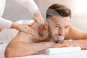 Happy middle aged man attending spa salon