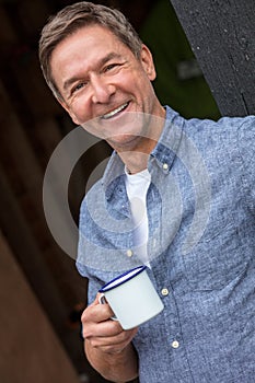 Happy Middle Aged Man Drinking Tea or Coffee Outside