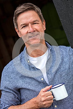 Happy Middle Aged Man Drinkng Tea or Coffee Outside