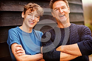 Happy Middle Aged Man Father and Teenage Son Arms Folded