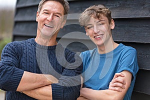 Happy Middle Aged Man Father and Teenage Son Arms Folded