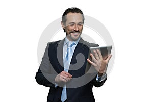 Happy middle-aged man holding a tablet.