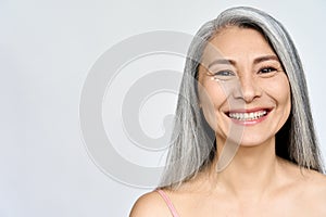 Happy middle aged mature asian woman headshot portrait. Skin care, eye care ads