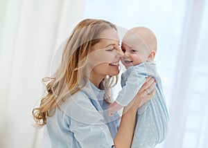 Happy middle aged mother with her child in a bed