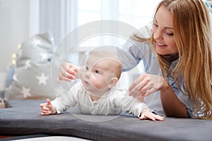 Happy middle aged mother with her child in a bed